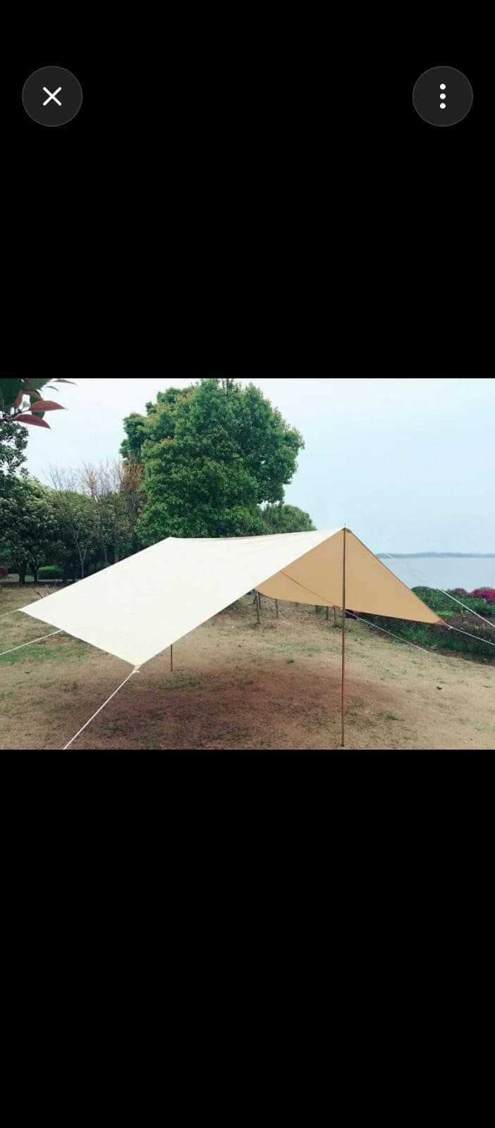 Canvas rain tarp, guy-lined shelter