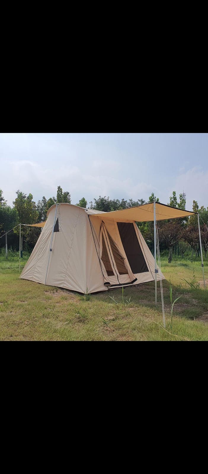 A-frame tent pitched under trees